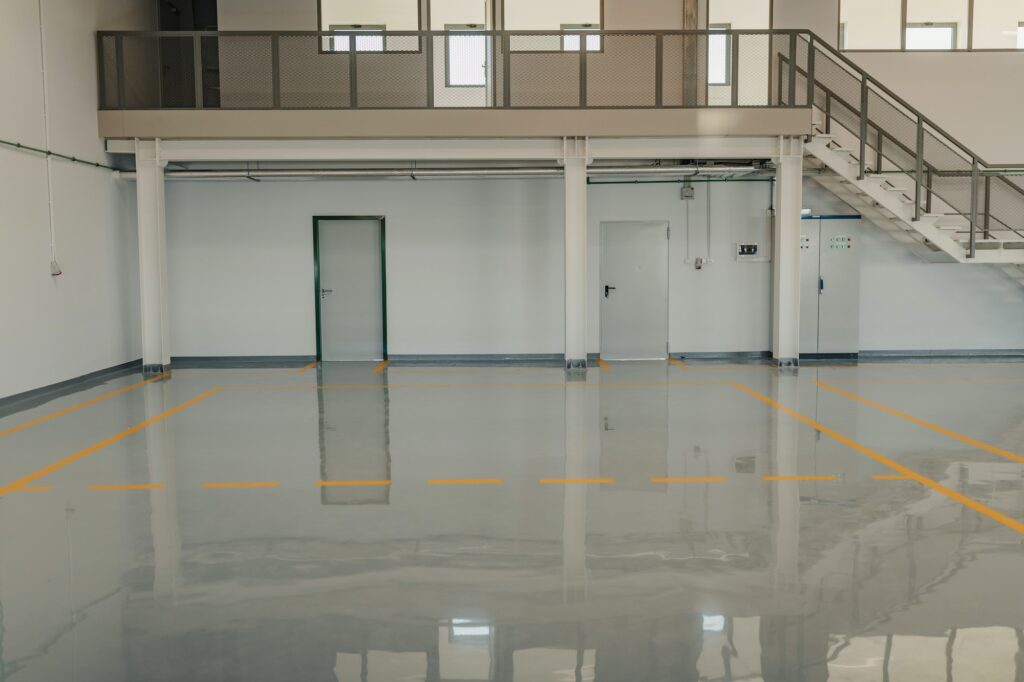 New resin floor coating and marking signs in a car workshop.