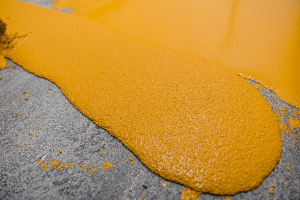 Selective focus on the yellow floor of freshly applied epoxy mortar system